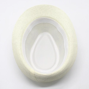 Macro shot of ivory straw hat interior featuring fine weave and white sweatband detail