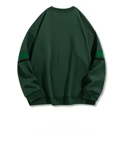 Detail view of contrast stripe stitching on shoulders of dark green crewneck sweatshirt