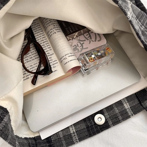 Internal view of a spacious grey plaid wool tote bag showing storage capacity