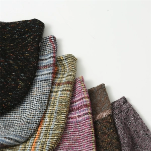 Close-up of colorful knitted scarves with rich texture and woven pattern detail