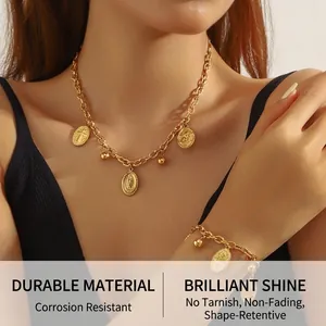 Detail of vintage gold plated coin pendant necklace and matching chain bracelet set