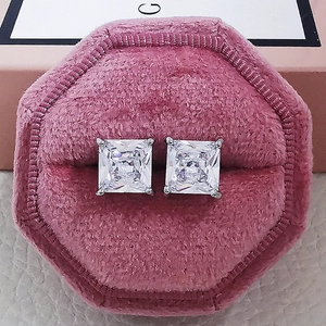 Close-up of princess cut cubic zirconia stud earrings in a pink velvet jewelry box
