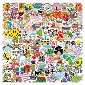 Flat lay of 100pcs waterproof PVC stickers with VSCO aesthetics for guitars and luggage