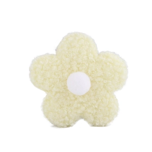 Detail shot of soft yellow teddy fleece flower accessory with white center pompom