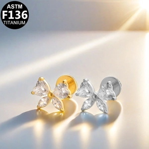 ASTM F136 titanium bow stud earrings in gold and silver finish with sparkling gemstones