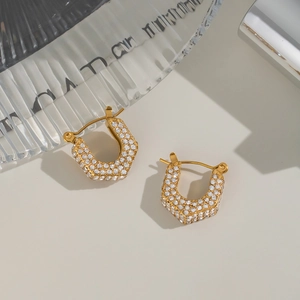 Macro shot of 18K gold plated U-shaped earrings with sparkling cubic zirconia inlay