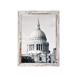 Detail of vintage white distressed wooden picture frame with architectural art print