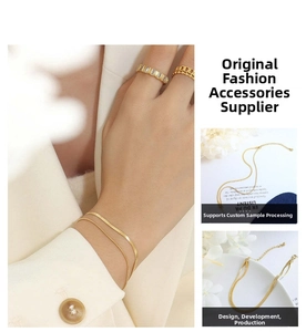 Detail of gold-plated double-layer snake chain bracelet and zircon ring set on hand