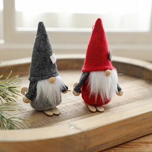 Handmade Christmas gnome set with grey and red felt hats on wooden skis decor