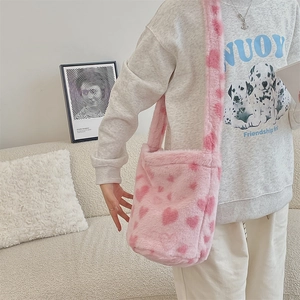 Detailed view of pink plush leopard print bucket bag with heart patterns for winter