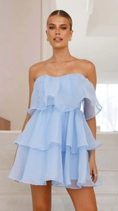 Detail of light blue strapless ruffled dress with light translucent tiered layers