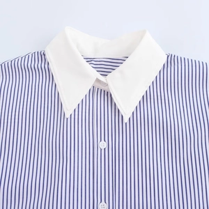 Close-up of blue and white striped shirt with contrasting white pointed collar and buttons