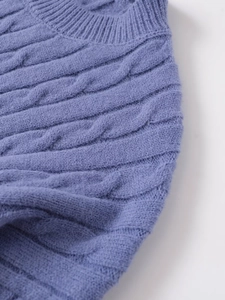 Détail de la maille torsadée et du col rond côtelé sur un pull gris lavande élégant