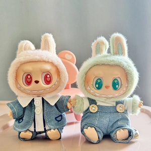 Close-up of Labubu dolls wearing pink and green rabbit ear hats and denim outfits