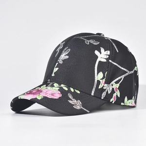 Detailed close-up of intricate floral embroidery on a black structured baseball cap