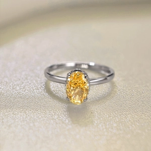 Macro shot of S925 sterling silver ring showing yellow oval cut stone and engraved hallmark