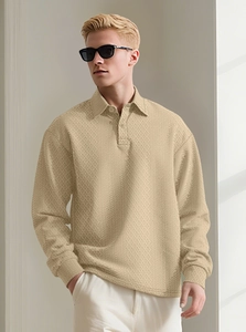 Close-up of khaki knit long-sleeve polo shirt with detailed geometric textured pattern
