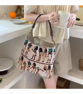 Detail of vintage Pharaoh jacquard tote bag with leather strap and wooden beads decoration