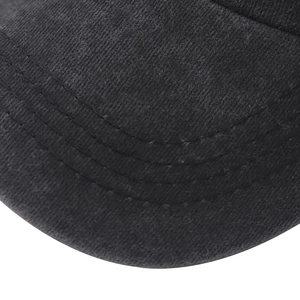 Macro detail of black washed cotton twill fabric with precision triple stitching on cap brim