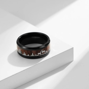Minimalist black stainless steel ring with wood inlay featuring forest elk silhouette