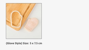 Detail of mitten-shaped cookie mold set with snowflake texture and sugar frosting finished cookie