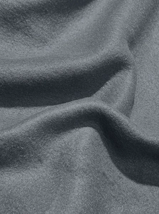 Close-up of thick dark grey suede-like fabric texture with soft natural draping folds