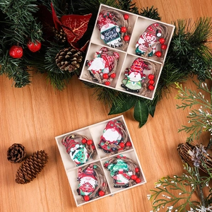 Detail of four painted Christmas gnome wooden ornaments in a natural wooden box