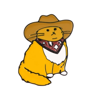 Cute yellow cowboy cat enamel pin featuring a brown hat and red patterned bandana