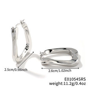 Macro detail of chunky silver twisted U-shaped earrings with reflective mirror finish
