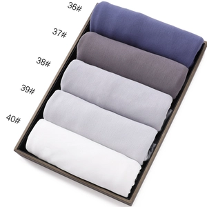 Detail of rolled mercerized cotton jersey scarves in five elegant gradient cool tones