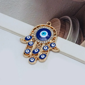 Detailed Hamsa Hand charm with blue evil eye beads and sparkling white crystals