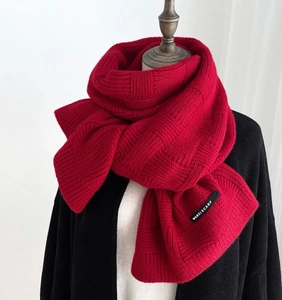 Red knit checkerboard scarf with premium wool texture and woven brand label
