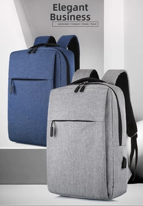 Front view of grey and blue waterproof business backpacks with external USB charging ports