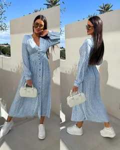 Detail of light blue floral V-neck maxi dress with long sleeves and button accents