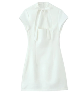 Detail of white mini dress featuring bow tie collar and U-shaped cutout design