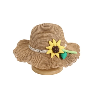 Children's summer straw sun hat with a large yellow sunflower decoration and white lace trim