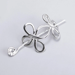 Silver Celtic knot viking hair pin with spiral metal design on grey background