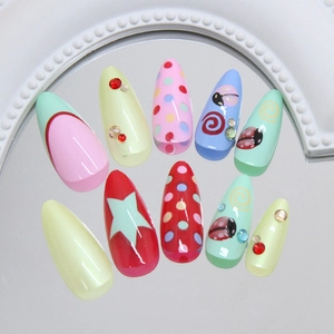 Colorful almond press-on nails with ladybug, polka dots, and rhinestones