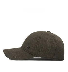 Side view of dark brown knitted winter baseball cap with textured weave and side logo