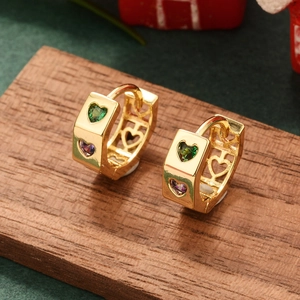 Macro shot of gold square earrings with heart-shaped green and purple zircon stones