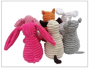 Detail of colorful corduroy squeaky plush dog toys in rabbit and animal shapes