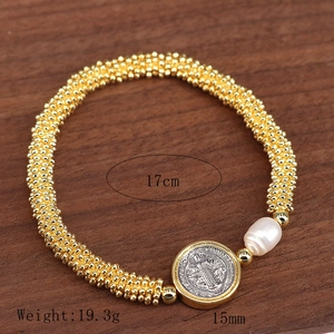 Gold beaded religious bracelet with Saint Benedict medal and baroque pearl charm