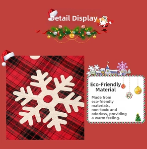 Detail of red and black plaid Christmas tree skirt with white felt snowflake applique