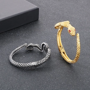 Punk vintage snake bangle in gold and silver steel with red eyes and scale texture