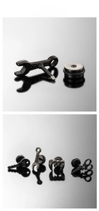 Detail of matte black gothic stud earrings in wrench, key, claw and scissor shapes