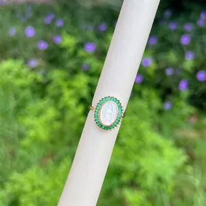 Close-up of 18K gold plated Virgin Mary ring with green zircon and shell cameo