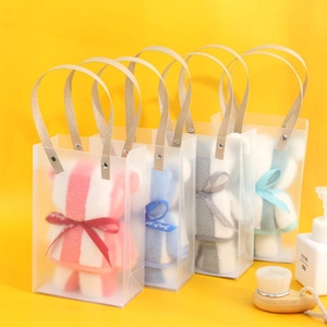 Macro shot of bear-shaped towels in transparent gift bags with Just for you ribbons