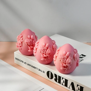 Pink egg-shaped silicone molds with intricate rose flower embossing for DIY candles