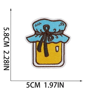 Macro detail of sunflower honey jar embroidery patch with black bow and size guide