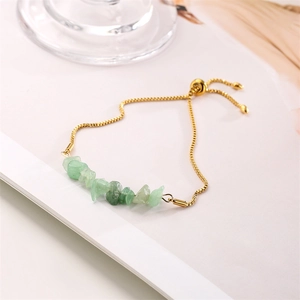 Detailed close-up of light green natural gravel beads on a gold stainless steel chain